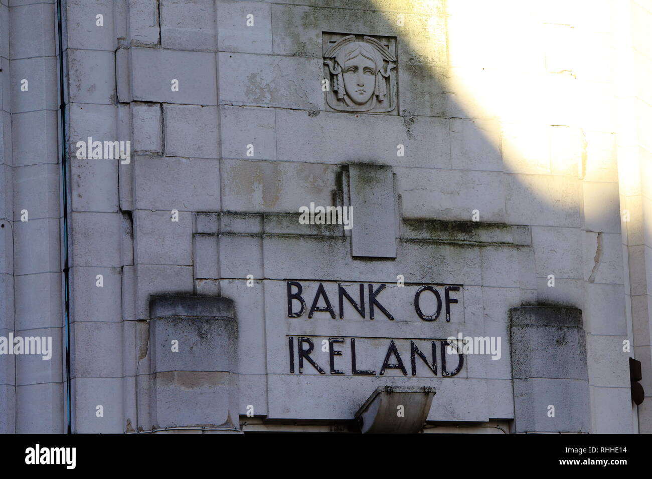 Old Bank of Ireland type font as seen on a building in Belfast, County Antrim. Standing on the corner of Royal Parade and North Street in the centre of Belfast (less than half a mile north of Donegall Square and the City Hall) the former Bank of Ireland Building is one of the finest Modernist buildings in Ireland. The building was constructed during 1929 and 1930 to designs by Joseph Vincent Downes. Born in 1891, Downes studied architecture at University College Dublin before graduating in 1920. During his studies Downes worked an apprenticeship at the architectural practice of Lucius O'Callag Stock Photo