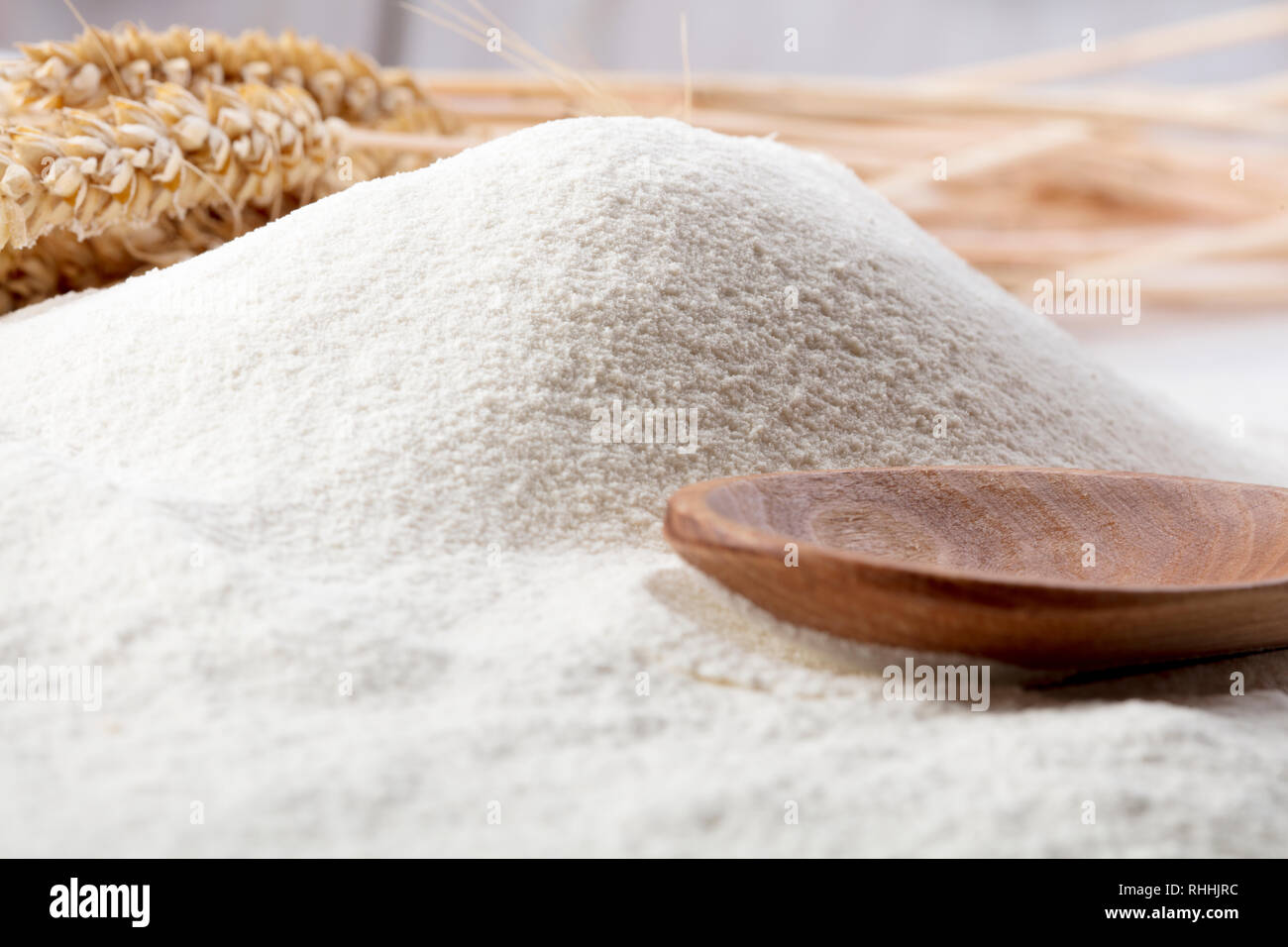 heap of wheat flour with ears of wheat Stock Photo