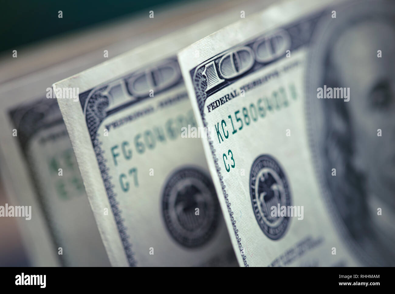 pile of one hundred dollars on green background Stock Photo