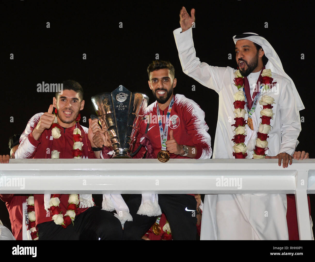 Doha, Qatar. . 2nd Feb, 2019. Qatar national soccer team captain and forward Hasan Al Haydos (C) and midfielder Karim Boudiaf hold the trophy upon arrival at Doha International Airport in Doha, Qatar on Feb. 2, 2019. Qatar won 3-1 over Japan to claim the title of the AFC Asian Cup for the first time. Credit: Nikku/Xinhua/Alamy Live News Stock Photo