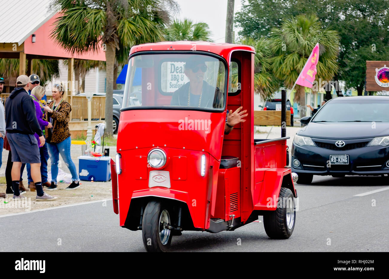 Dauphin Island, Alabama, USA. 2nd Feb, 2019. A man drives a vintage Cushman Truckster in the Krewe de la Dauphine Mardi Gras parade, Feb. 2, 2019, in Dauphin Island, Alabama. The Dauphin Island parade kicks off the official Mardi Gras parade season in Mobile, Alabama. Mobile’s first official Mardi Gras celebration was recorded in 1703.  (Photo by Carmen K. Sisson/Cloudybright) Credit: Carmen K. Sisson/Cloudybright/Alamy Live News Stock Photo