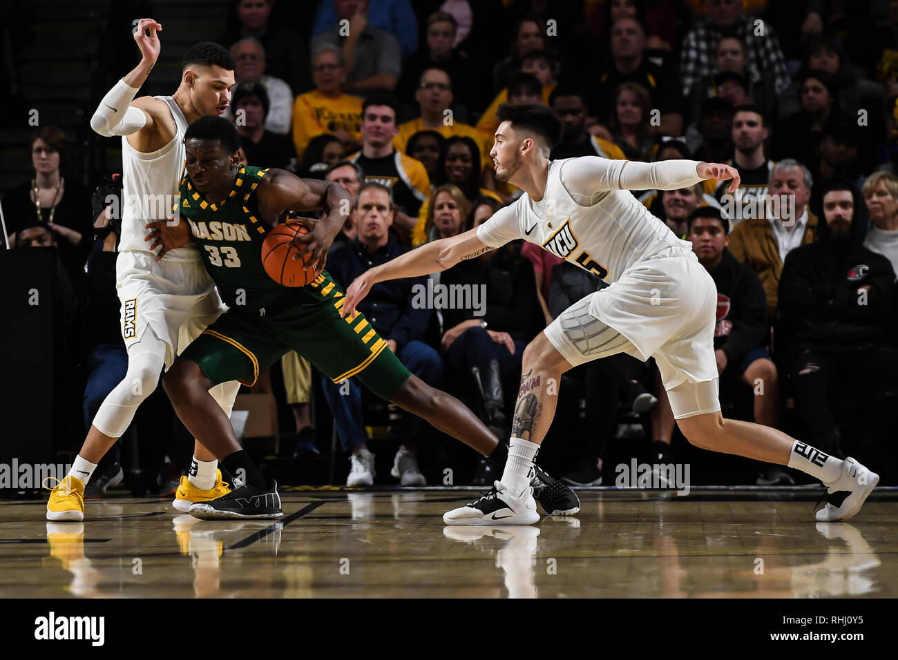 Richmond, Virginia, USA. 7th Jan, 2016. George Mason Forward GREG CALIXTE (33) drive toward the basket against MICHAEL GILMORE (22) and SEAN MOBLEY (5) during the game held at the Siegal Center Center in College Park, Maryland. Credit: Amy Sanderson/ZUMA Wire/Alamy Live News Stock Photo