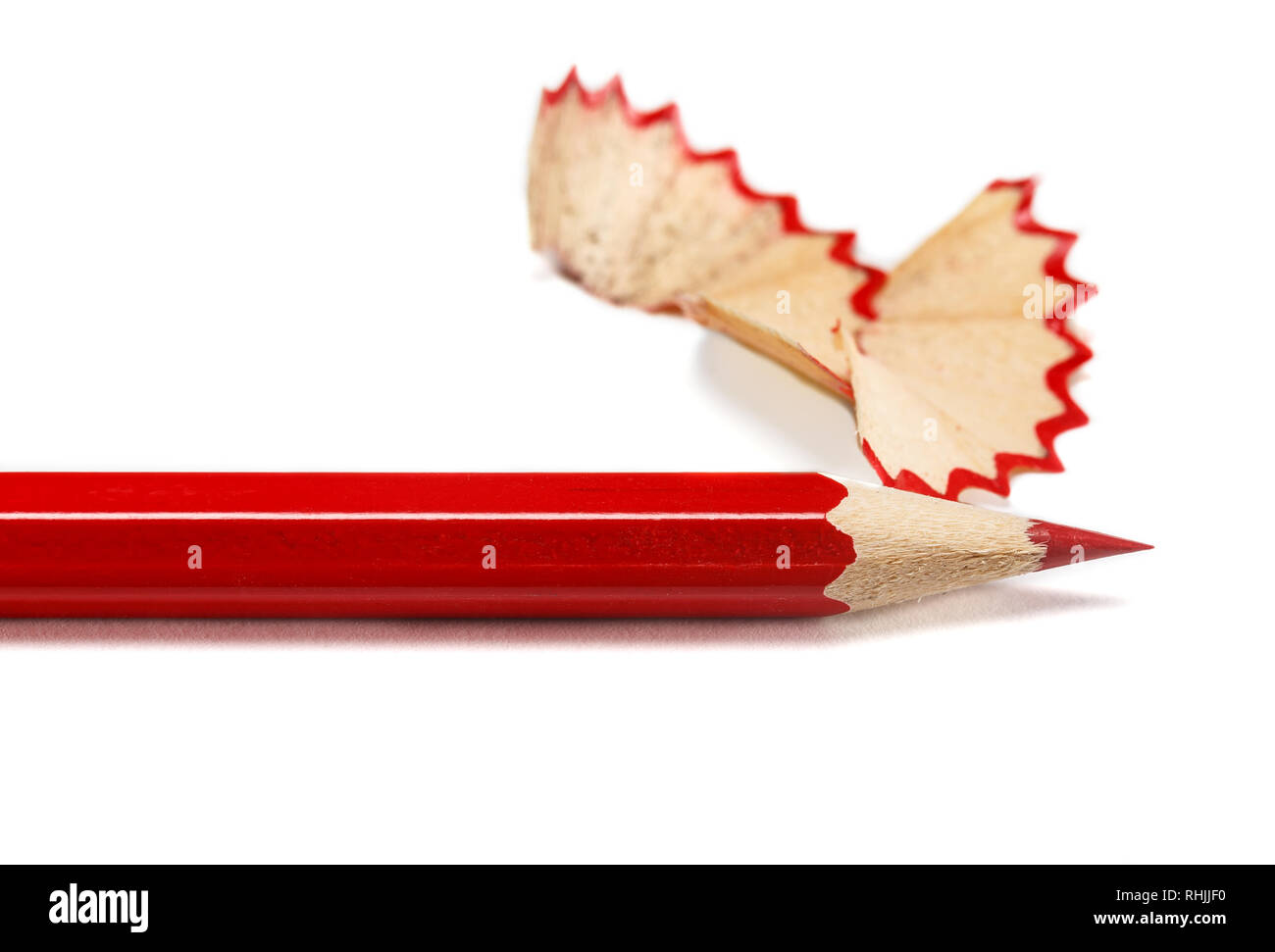 Red sharpened pencil close-up on a white background Stock Photo