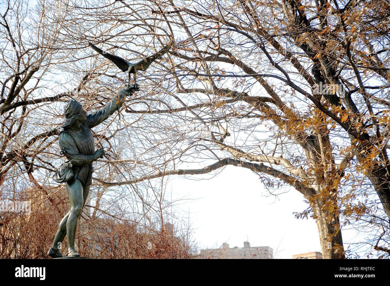 A cast iron sculpture called "The Falconer" is one of the public art pieces in New York City's Central Park. Stock Photo