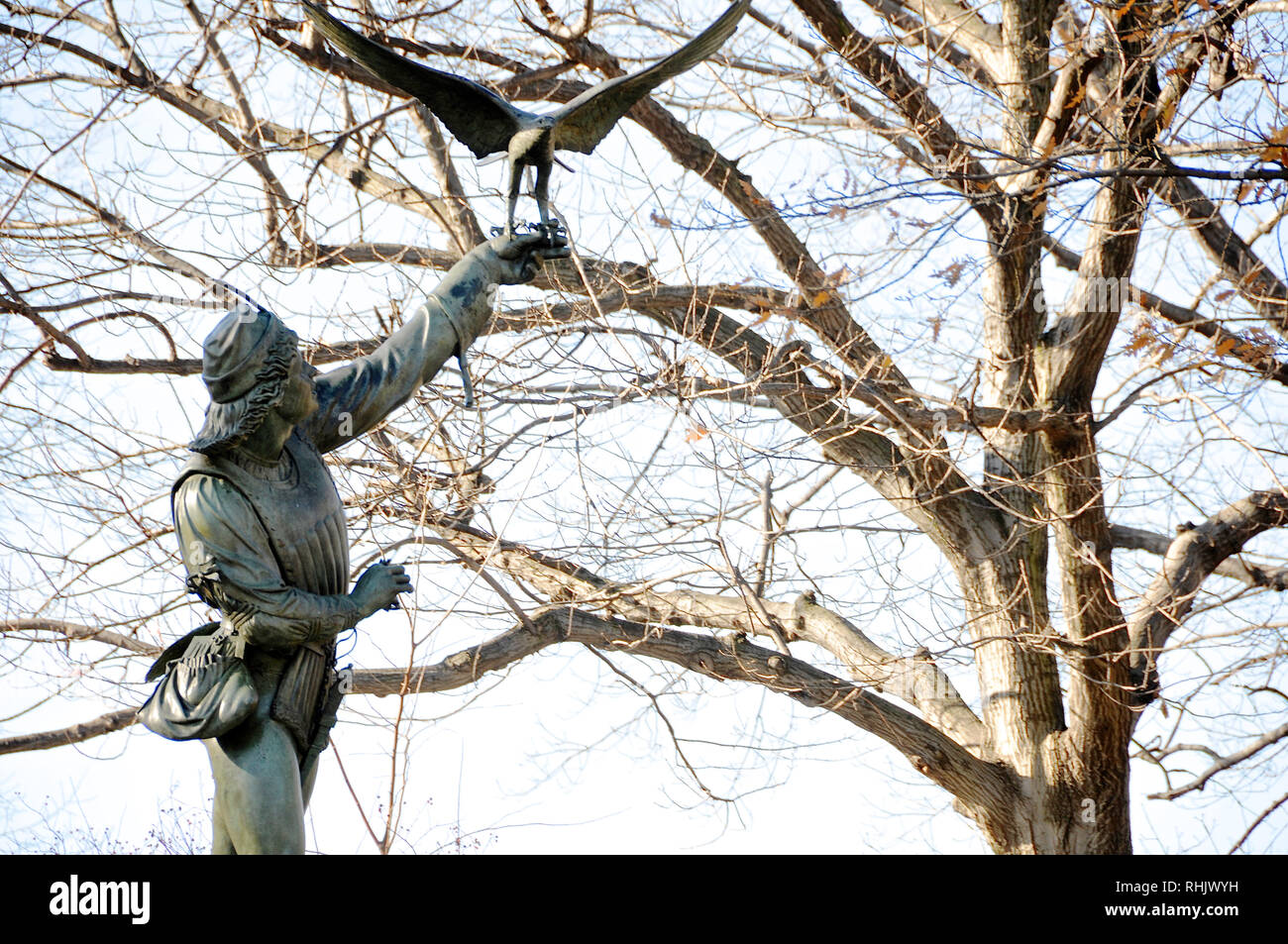 A cast iron sculpture called "The Falconer" is one of the public art pieces in New York City's Central Park. Stock Photo