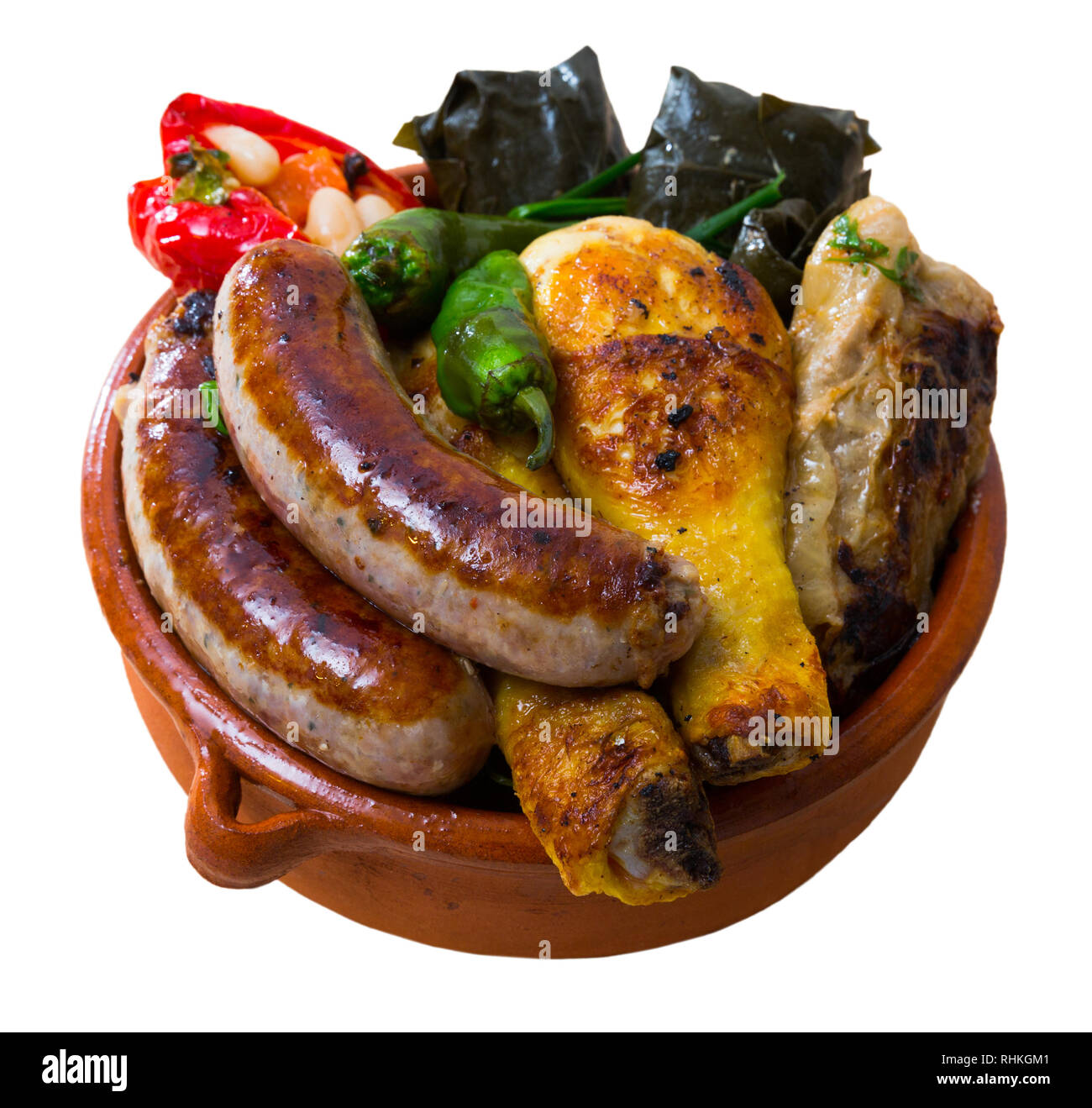 Kapama  a dish of bulgarian cuisine with assortiment meat, grape rolls and  stuffed pepper. Isolated over white background Stock Photo