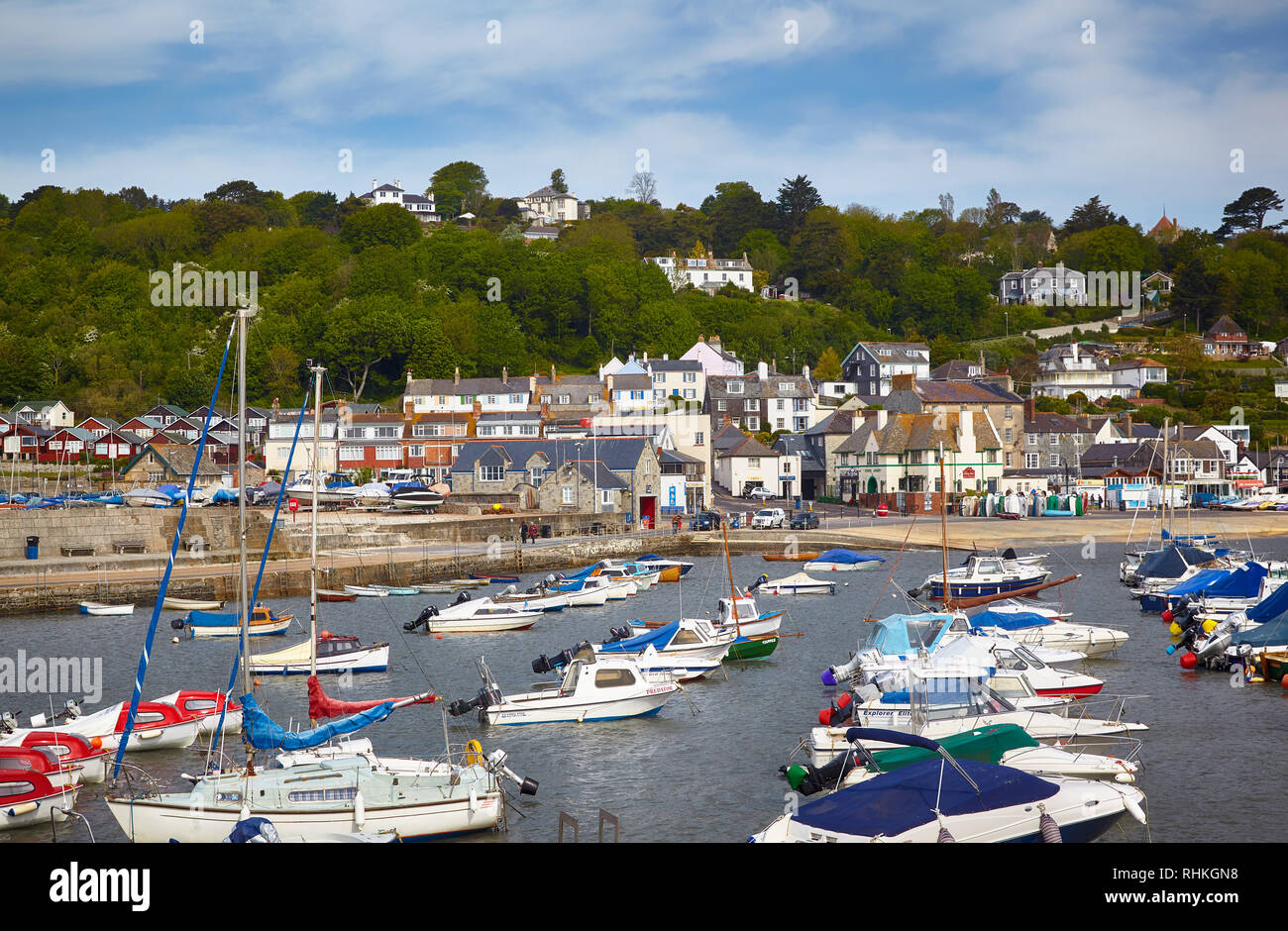 LYME REGIS, ENGLAND – MAY 12, 2009: The view of the famous Cobb harbor of Lyme Regis with the docked boats and yachts, with the Lyme Regis town on the Stock Photo