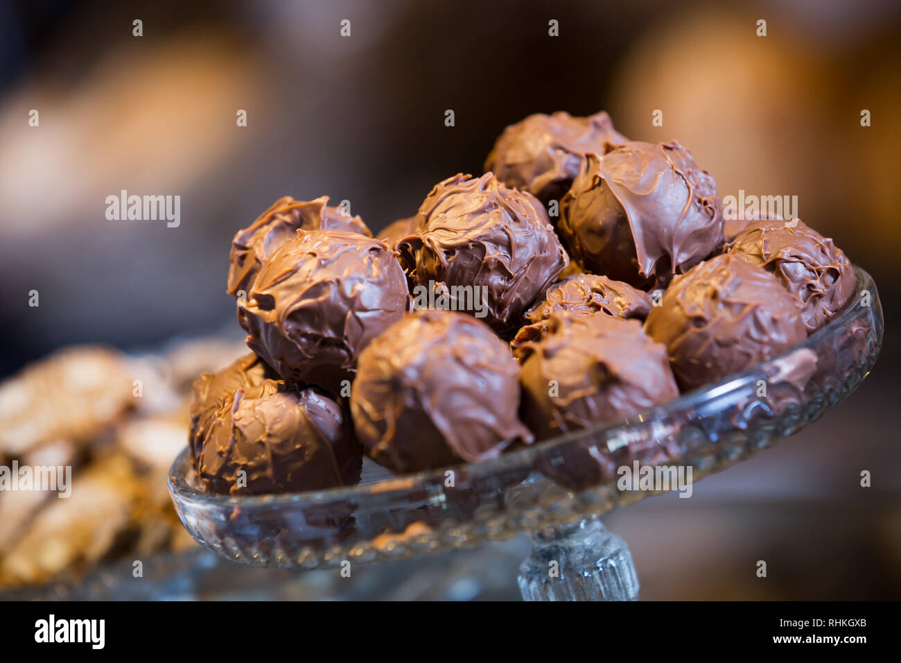 Sweet-stuff covered with chocolate syrup at bakery display Stock Photo
