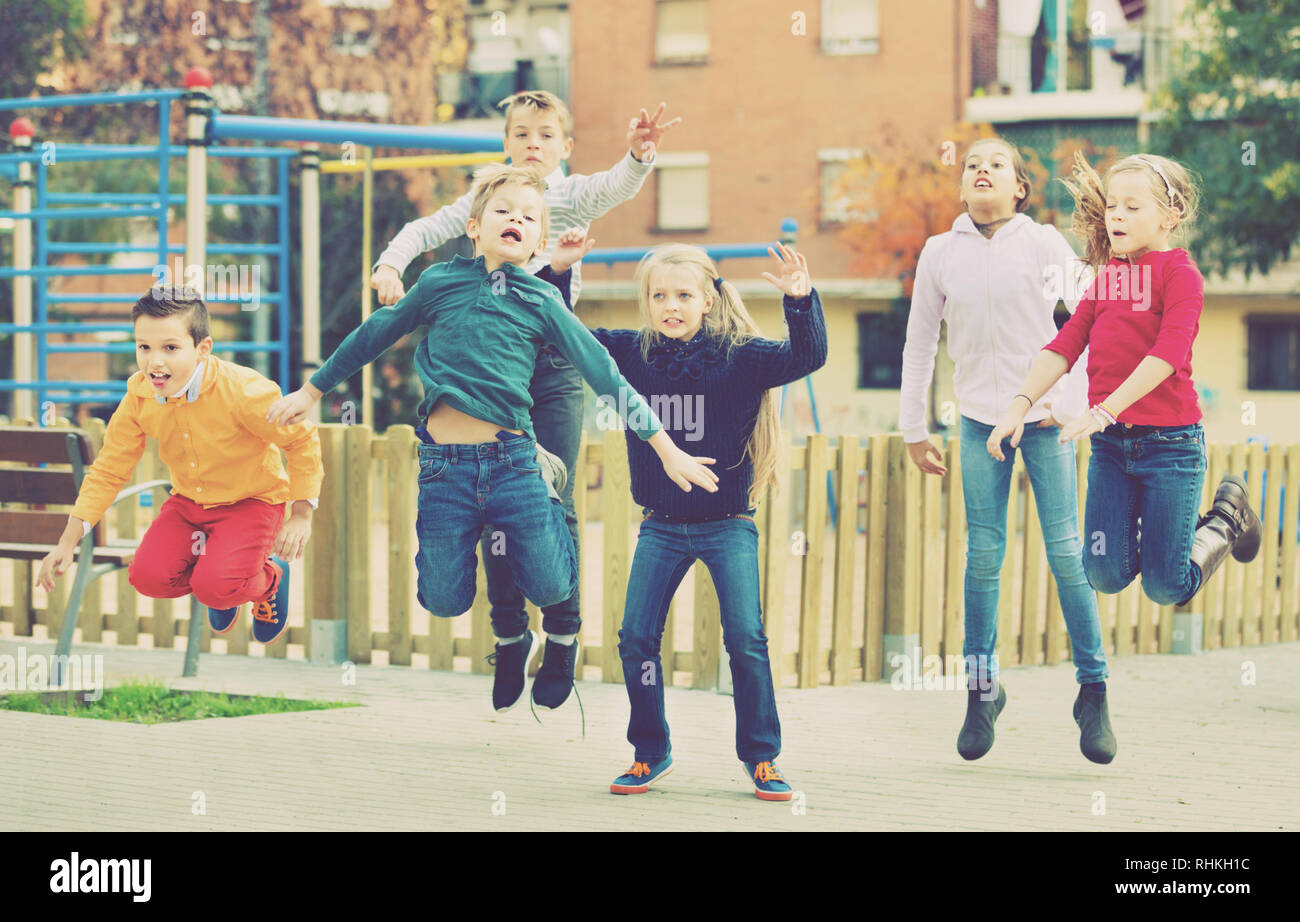 Happy laughing kids having fun and jumping up Stock Photo - Alamy