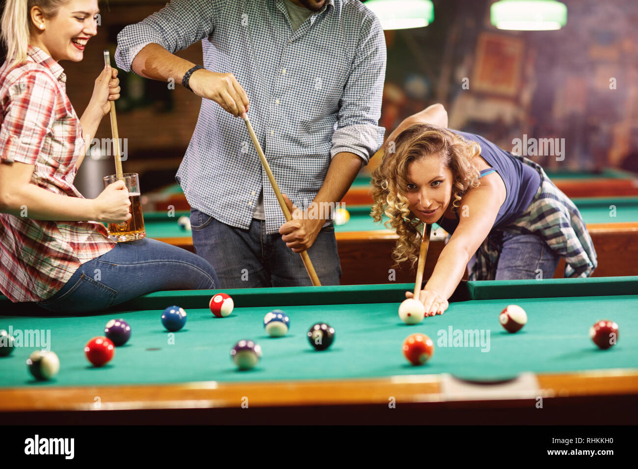 Billiards game. young friends playing pool together Stock Photo - Alamy