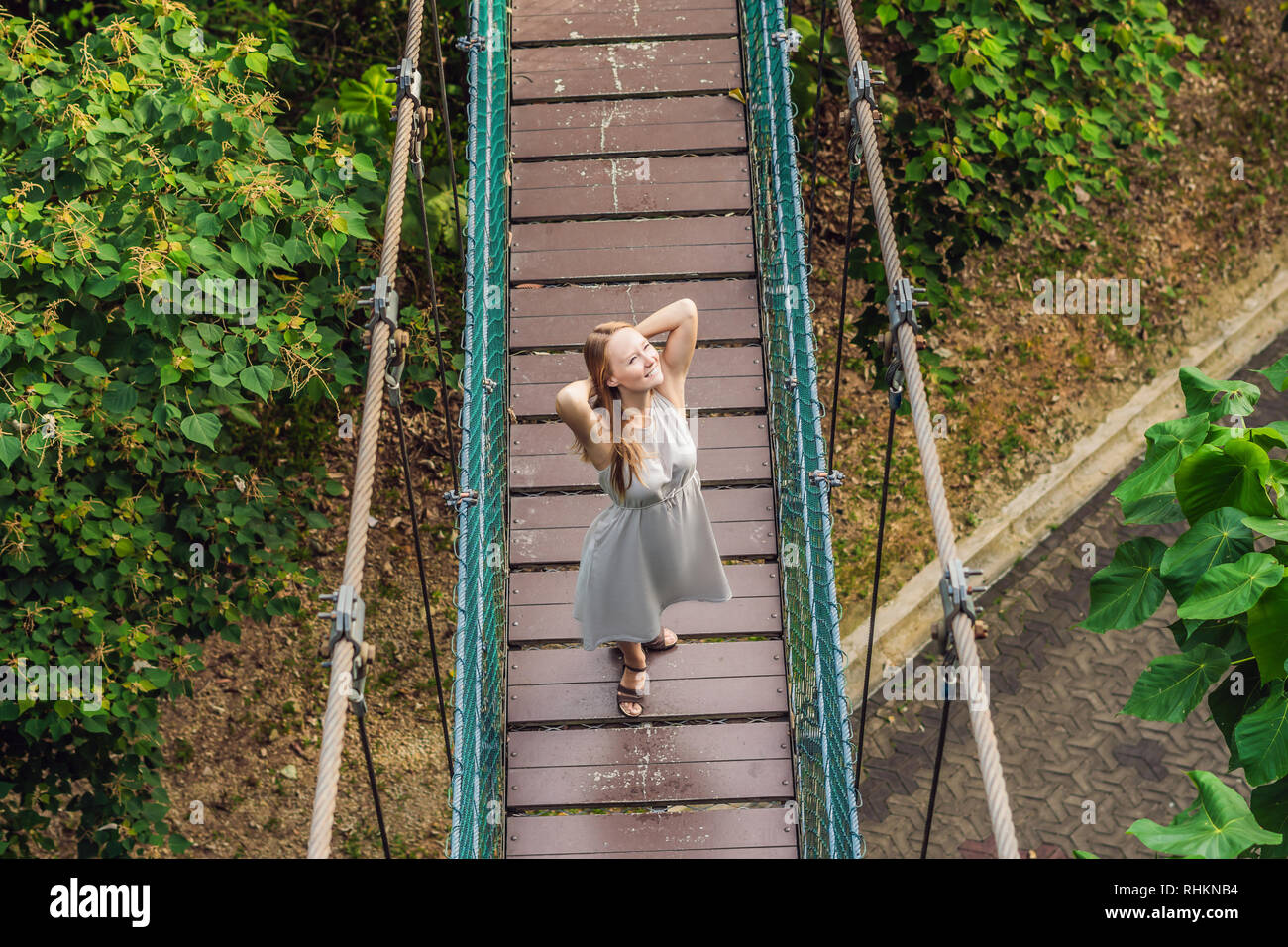 Young woman at the Suspension bridge in Kuala Lumpur, Malaysia Stock Photo