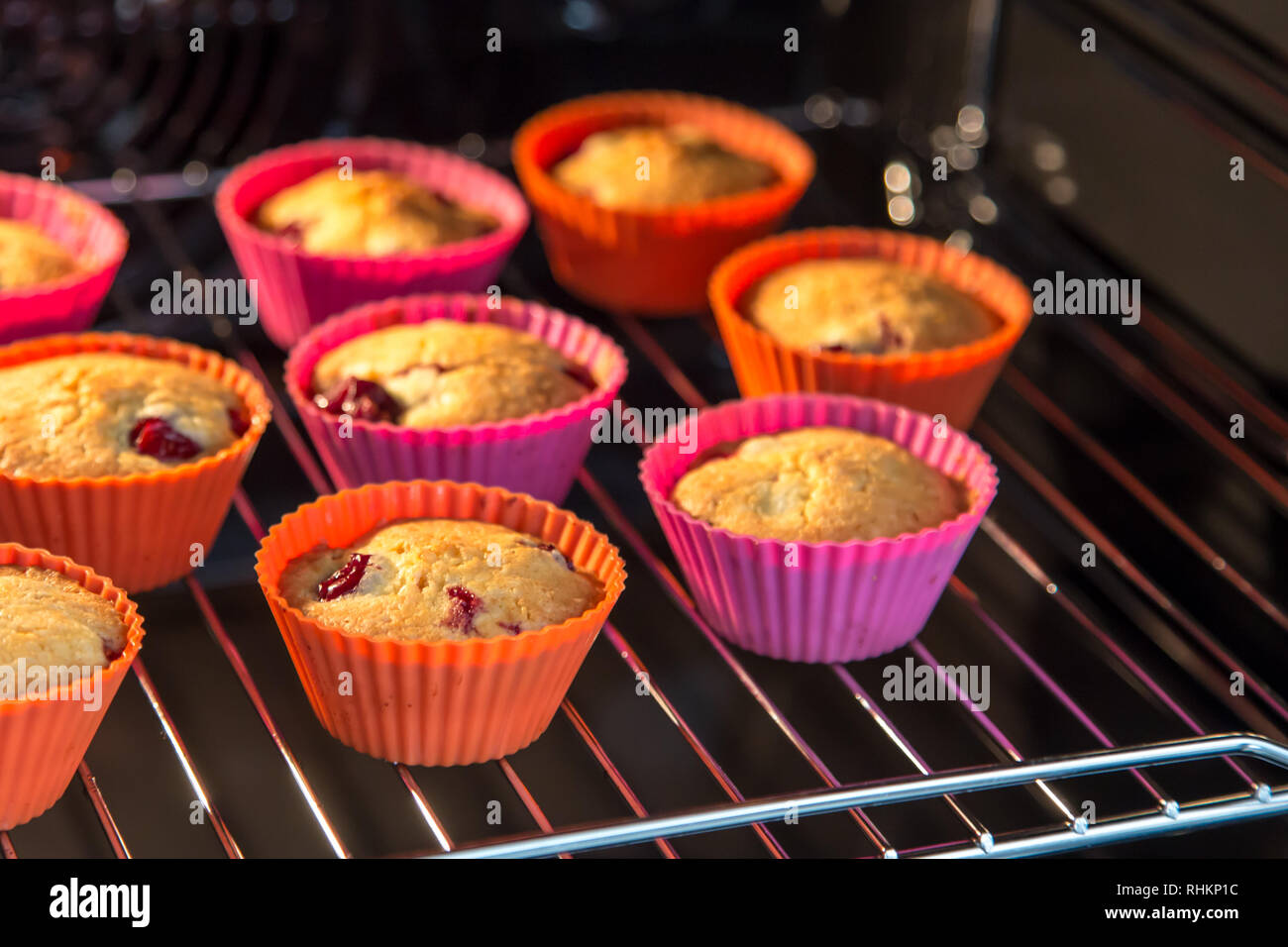 cupcakes with cherry, muffins in the oven Stock Photo - Alamy