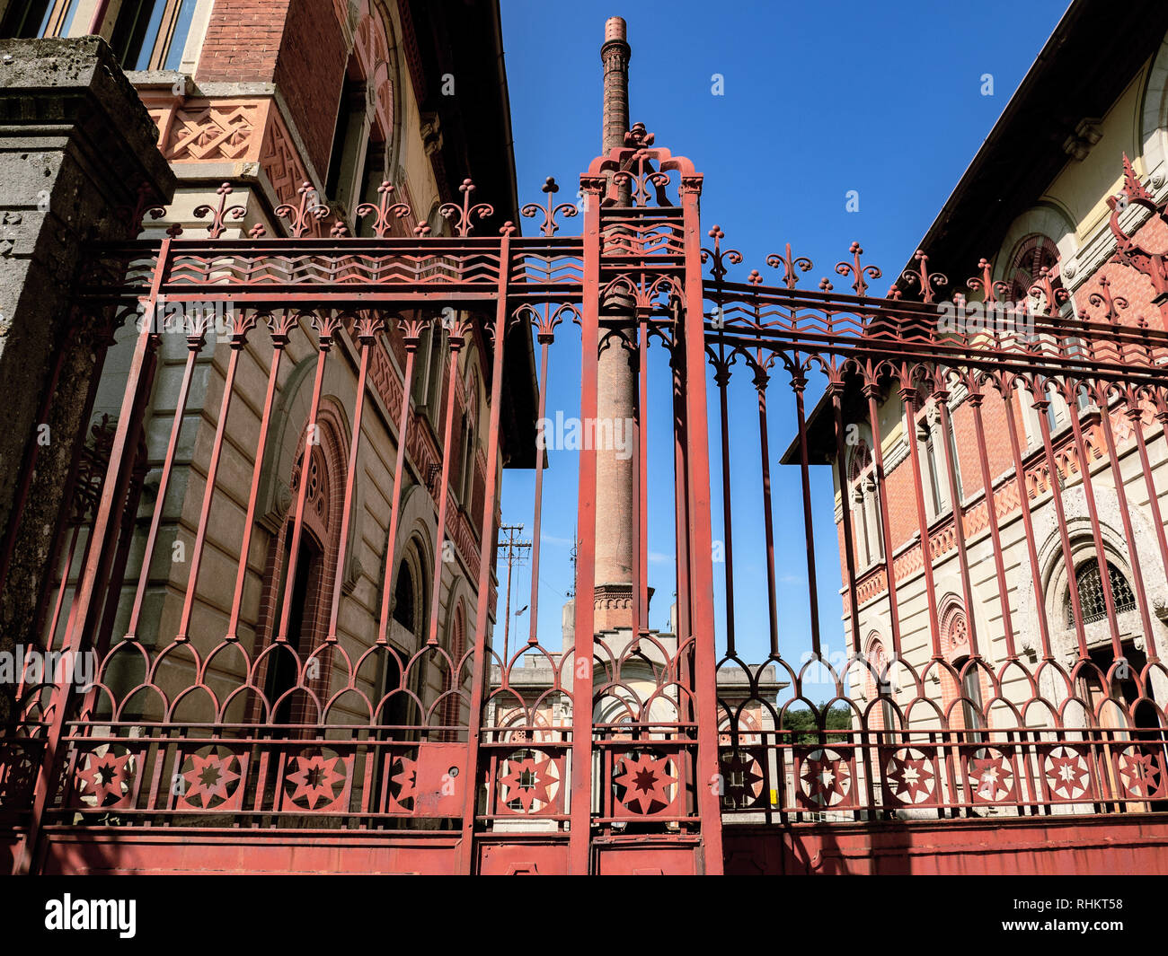 crespi d'adda - Lombardy, heritage of humanity. entrance to the factory, administrative offices and brick chimney. Stock Photo