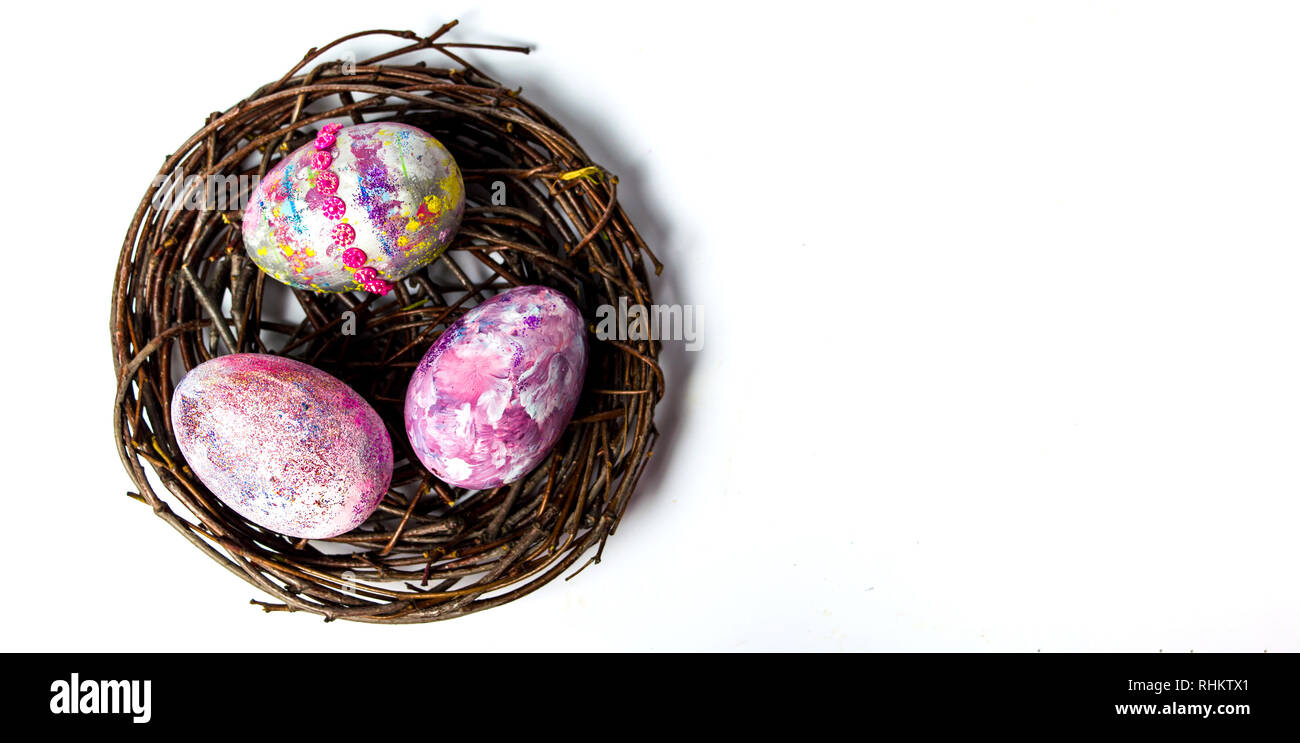 Easter eggs in a wicker nest top view Stock Photo