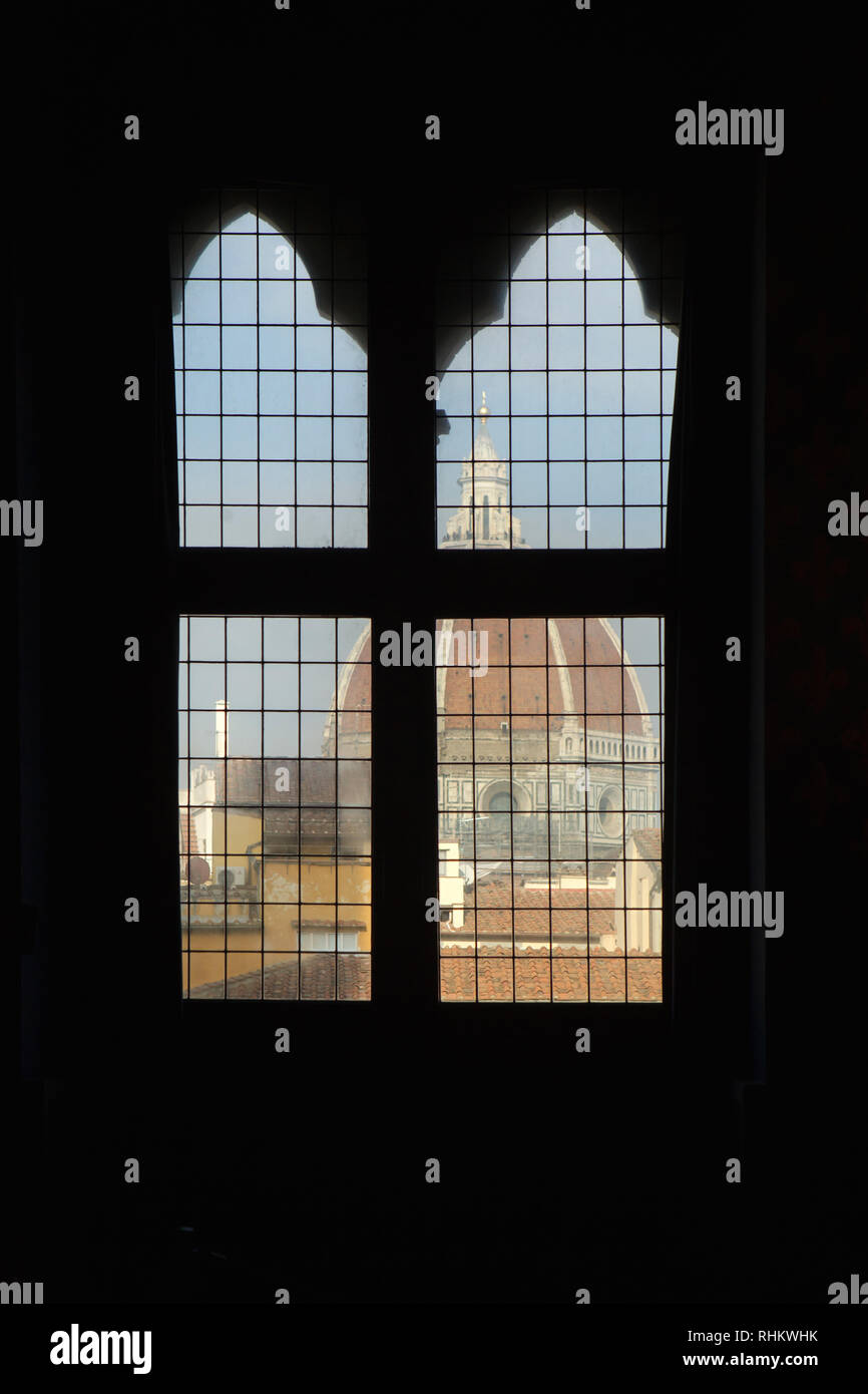 Florence Cathedral (Duomo di Firenze) pictured through the window of the Audience Chamber (Sala delle Udienze) of the Apartments of the Priori (Sale dei Priori) in the Palazzo Vecchio in Florence, Tuscany, Italy. Stock Photo