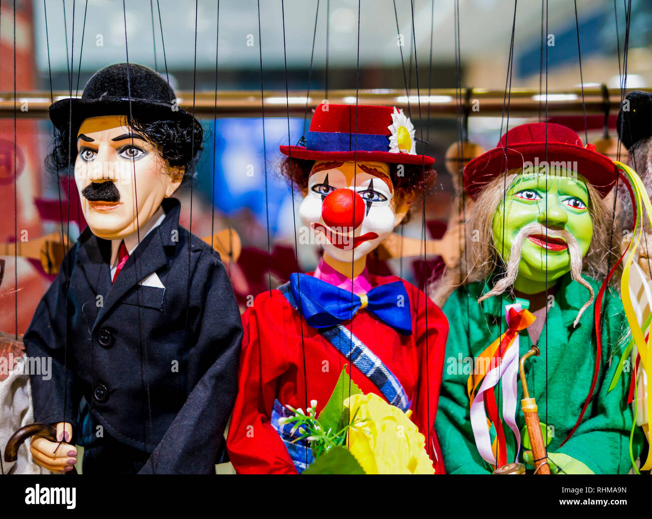 Row of traditional puppets - gentleman, clown and musician Stock Photo