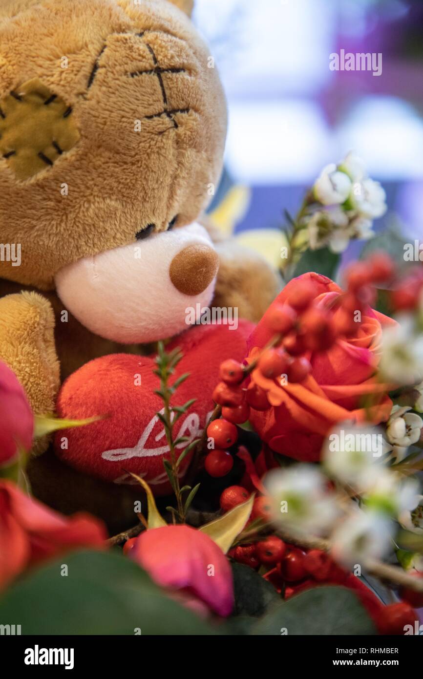 Cute Teddy Bear with love heart and flowers Stock Photo - Alamy