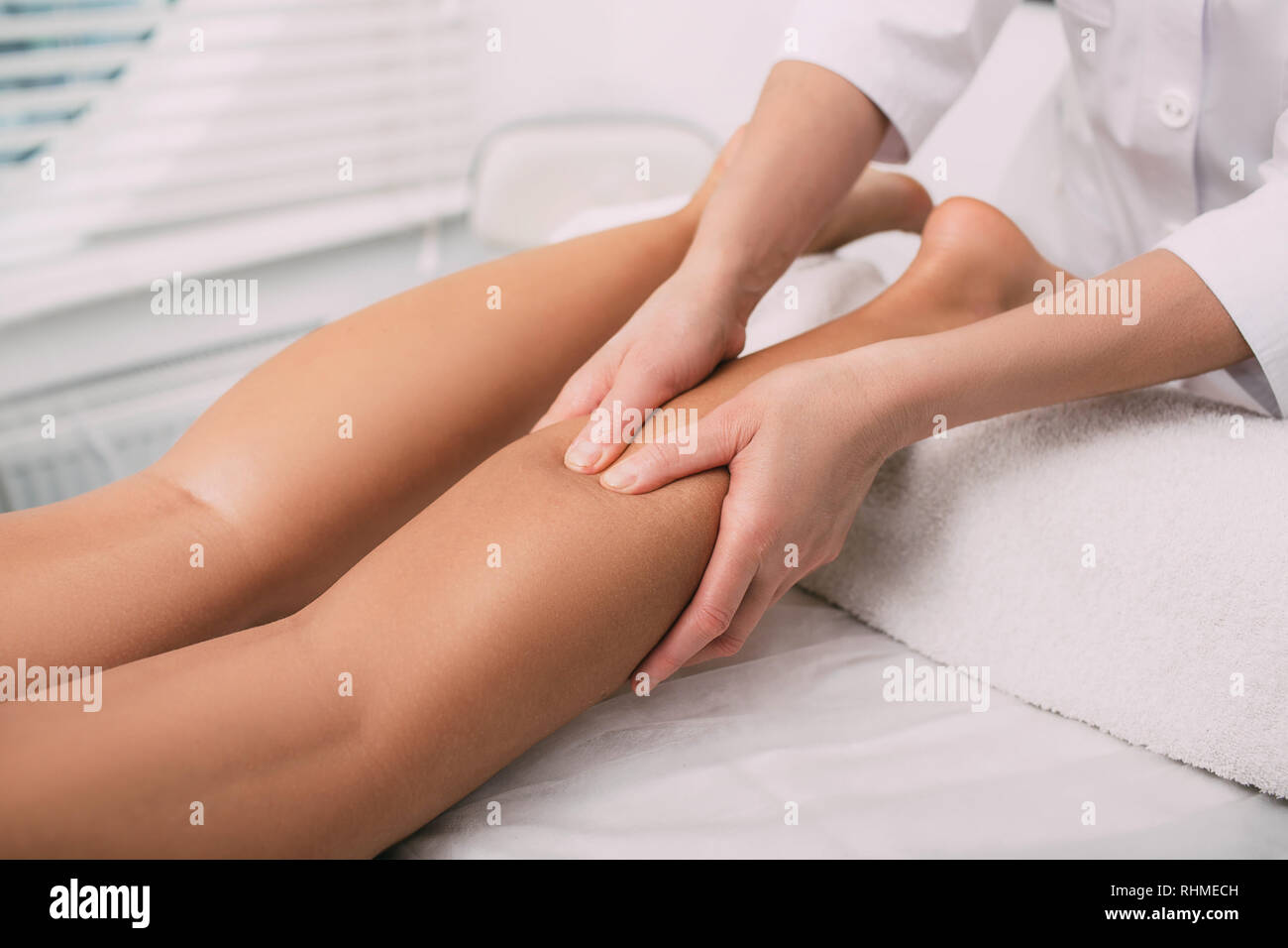 massage therapist makes relaxing leg massage, close-up Stock Photo