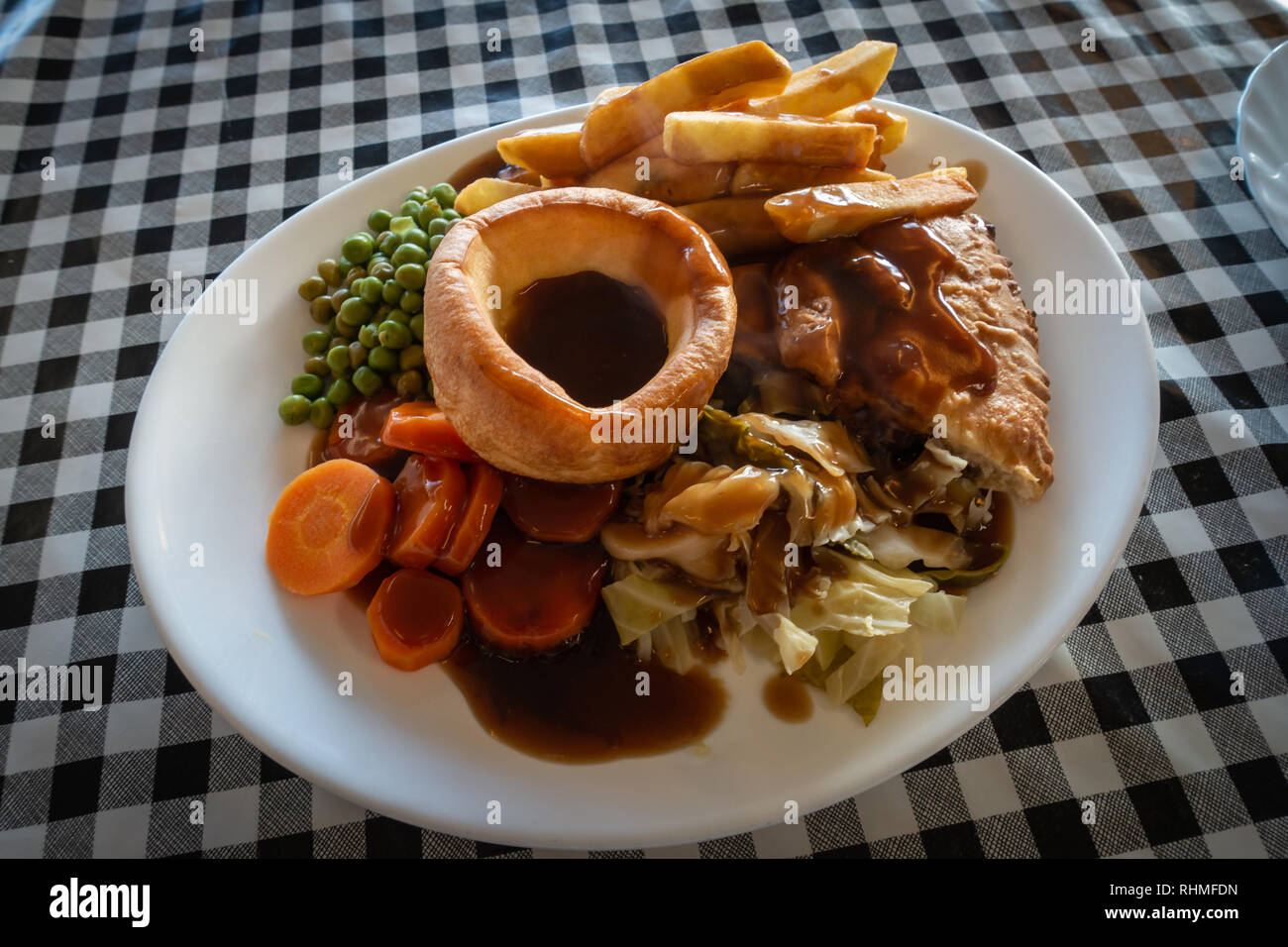 Plated Hot Steak meat Pie with Chips and gravy British Meal on a
