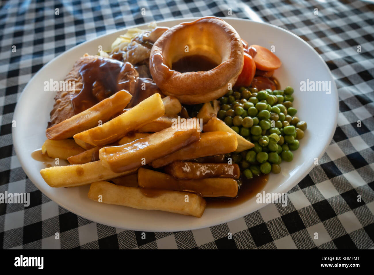 Plated Hot Steak meat Pie with Chips and gravy British Meal on a