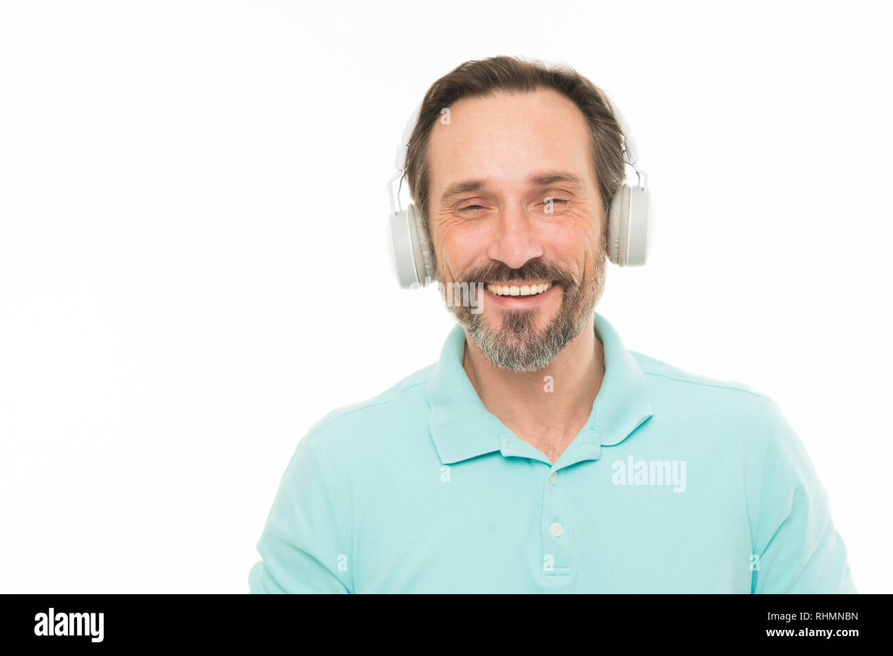 Live life loud. Mature man in stereo headphones. Happy bearded man
