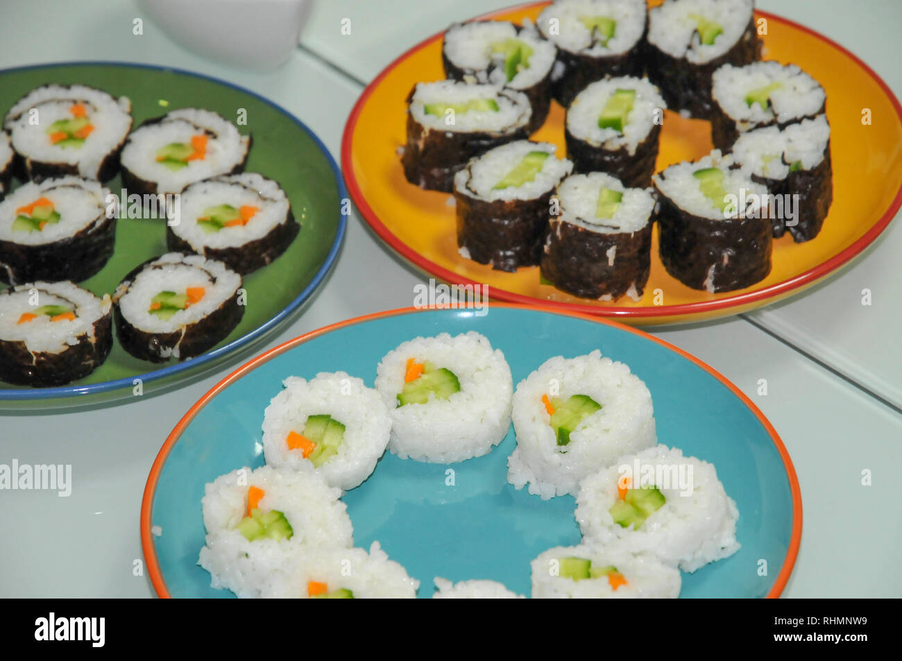 Platters of vegetarian sushi vegetables and rice wrapped in seaweed Stock Photo