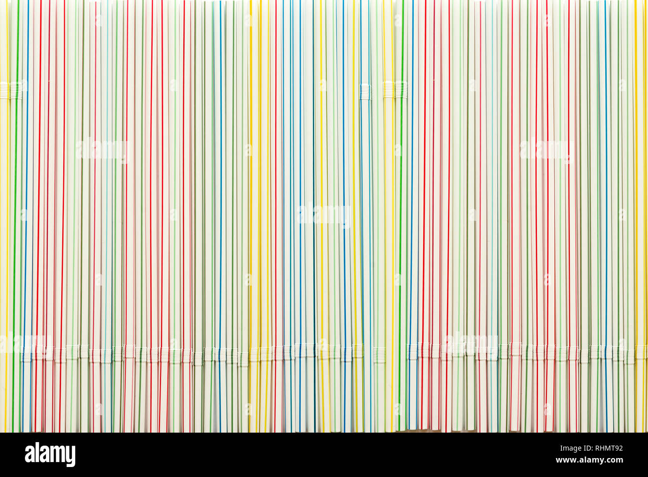 Striped colored plastic cocktail straws as background Stock Photo