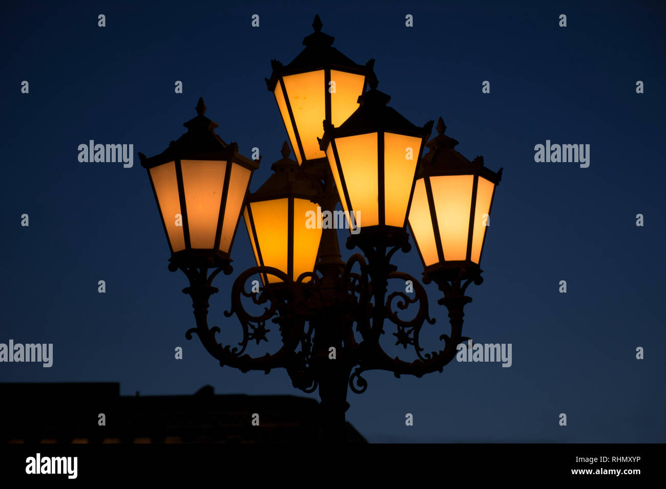 A street lamp at sunset, silhouette of lamp. Street lamp at night. A brightly lit street lamps at sunset. Decorative lamps. Armenia Stock Photo