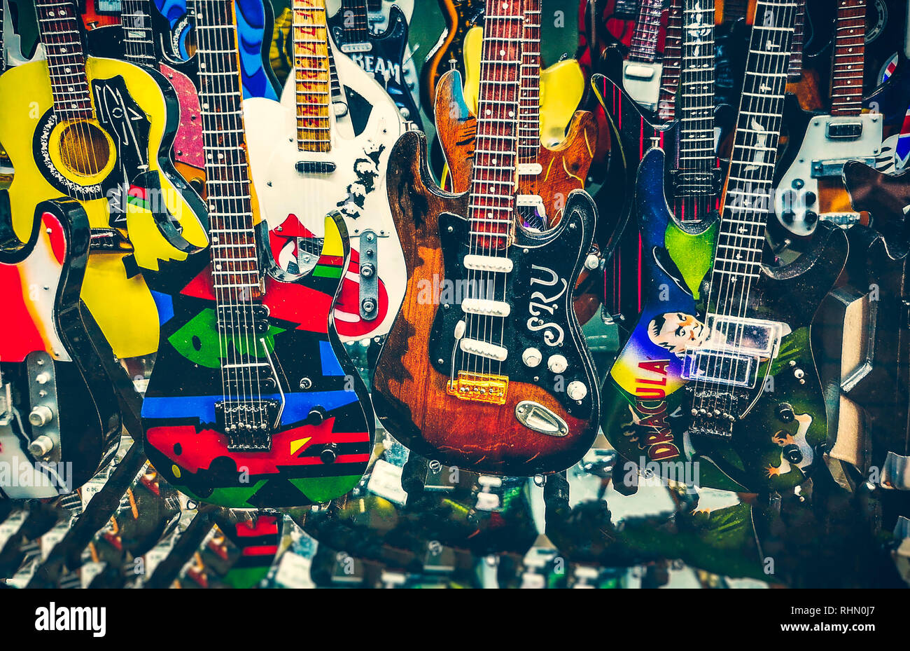 many mini electric guitars small toy models background Stock Photo