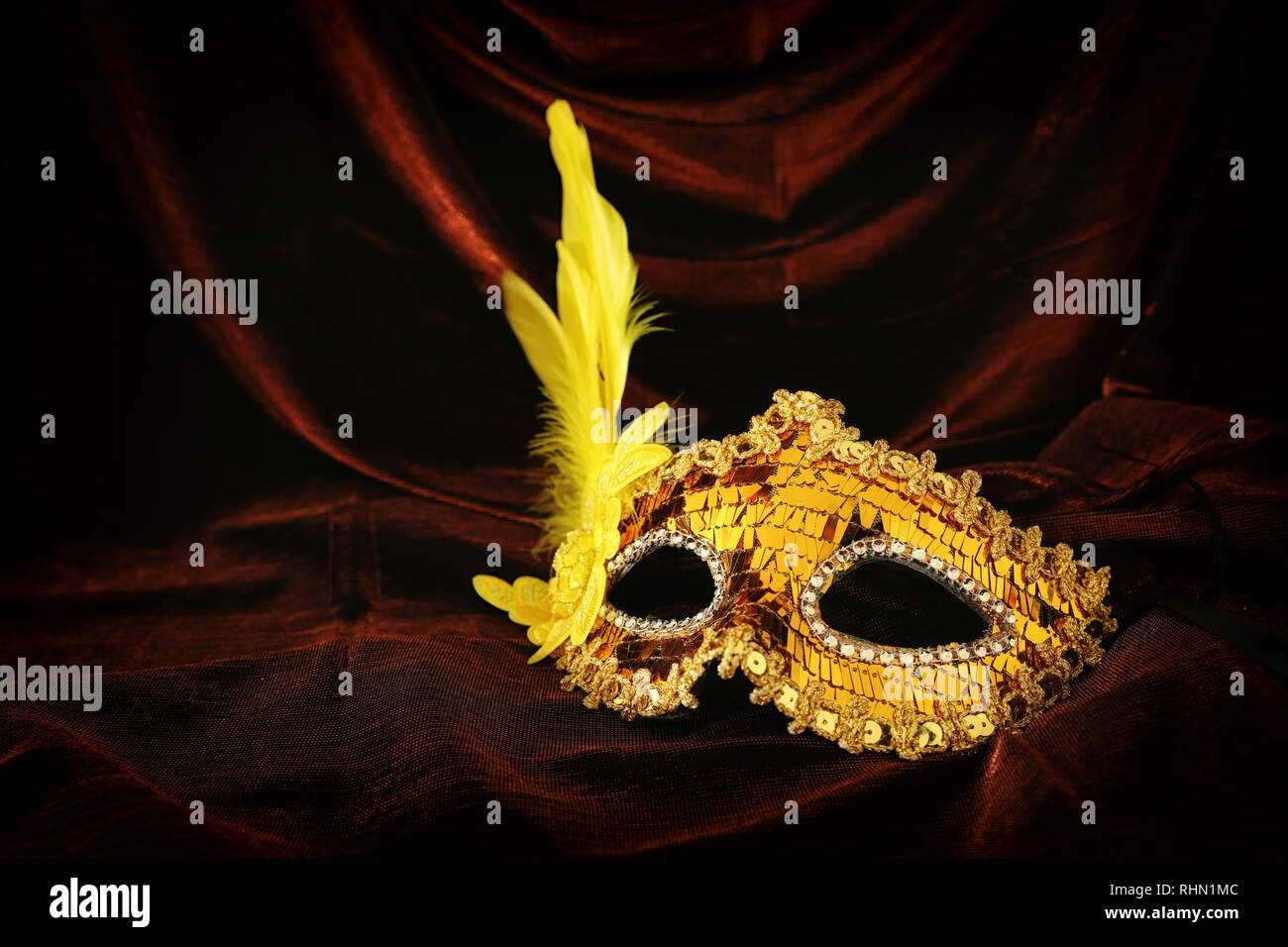 Photo of elegant and delicate gold venetian mask over dark velvet and ...
