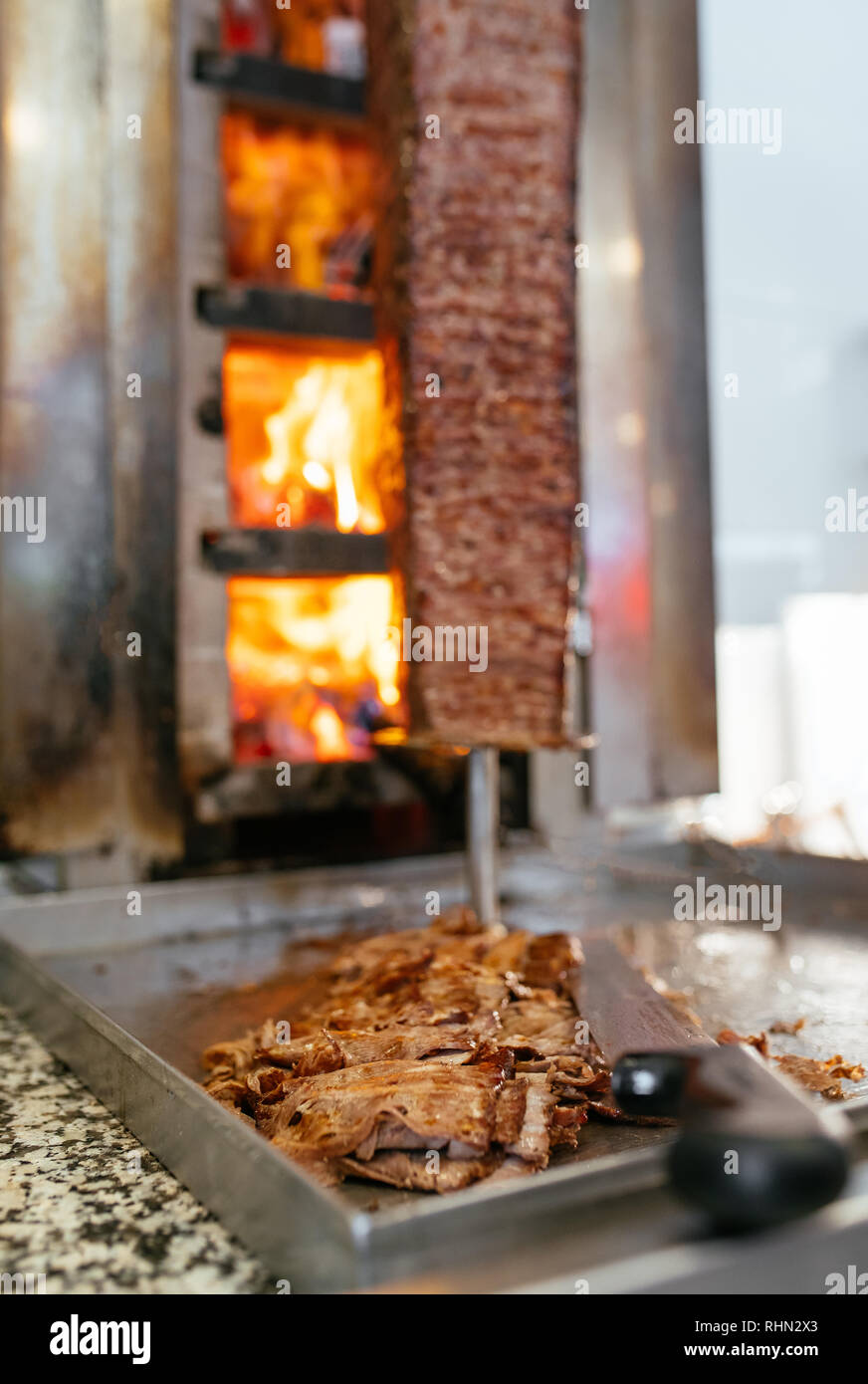Turkish Doner Kebab, Shawarma or Gyros. Chef cutting with doner knife ...