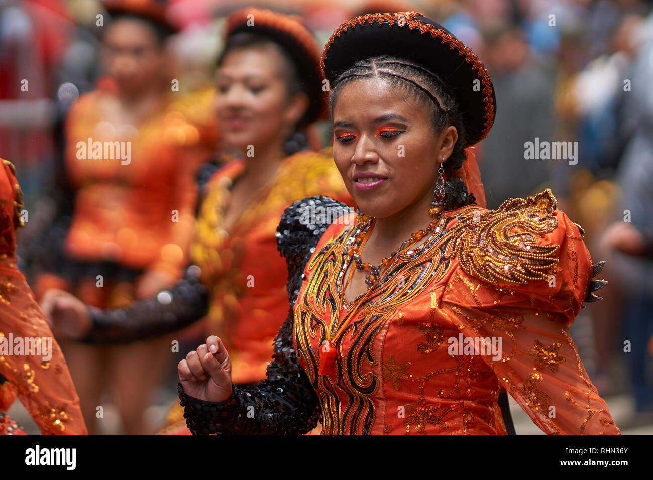 Caporales dancers in ornate costumes performing as they parade through