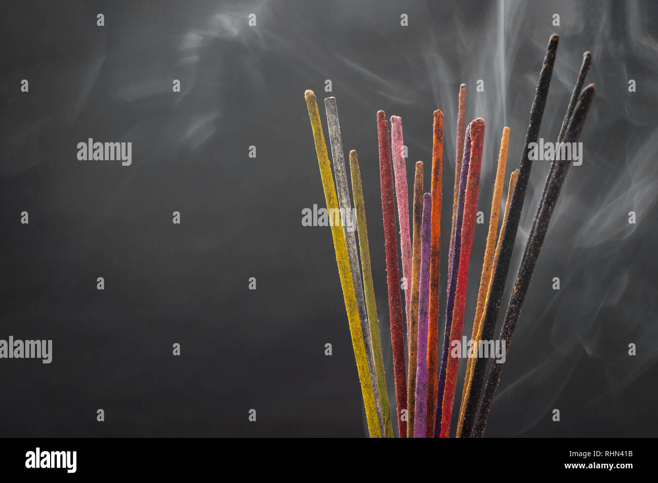 Handmade colorful incense sticks of different smells on black