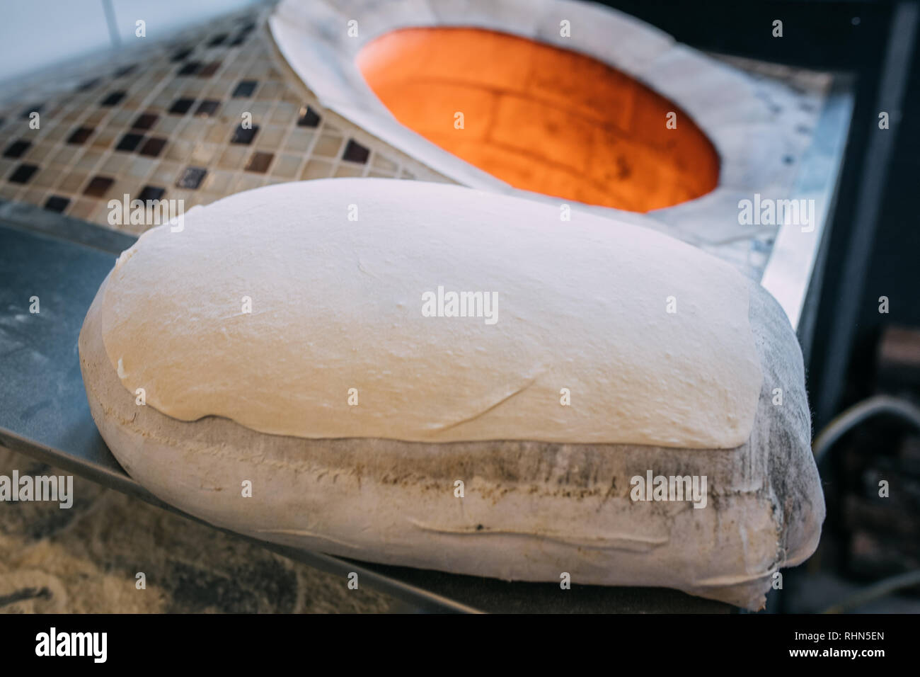 Traditional turkish wood fired stone brick oven and pita or pide bread dough. This stone oven for Turkish pide or pita bread. Also known as Tandir. Stock Photo