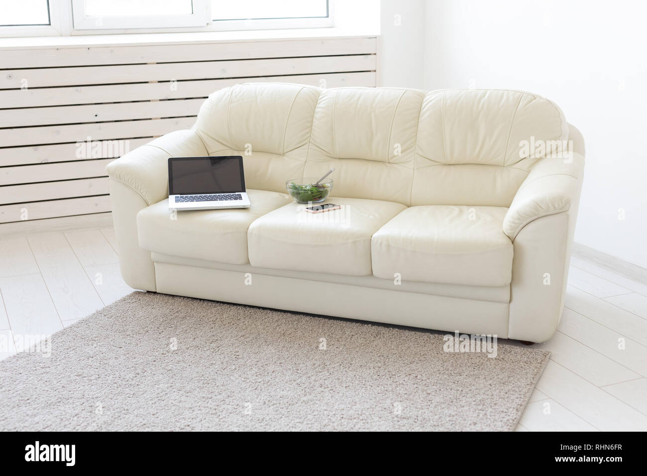 Sitting Room With Computer Business and interior concept - view of a white living room with sofa ...