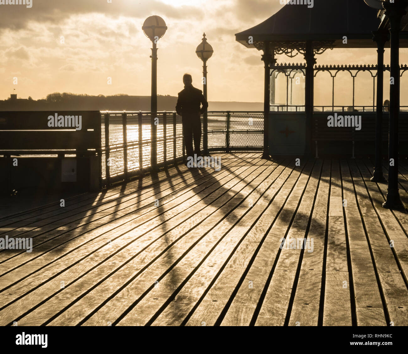 Winter sun creating dramatic light and silhouettes on Clevedon Pier. Stock Photo