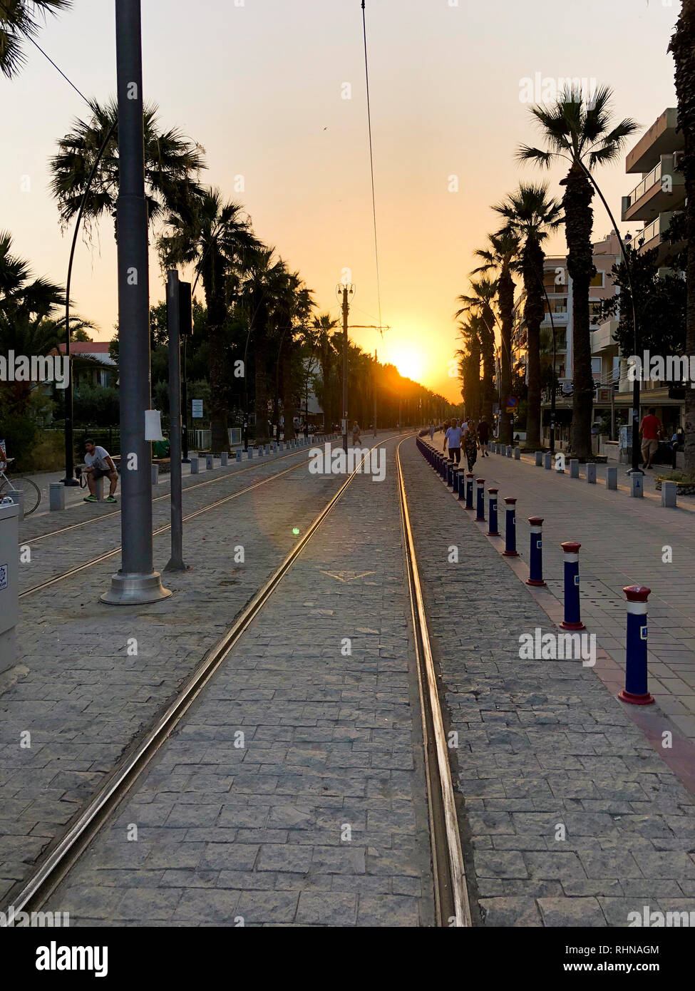 Izmir, Turkey - July 17, 2018: Rail ways of Izmir Tram at Bostanli Izmir on sunset. Stock Photo