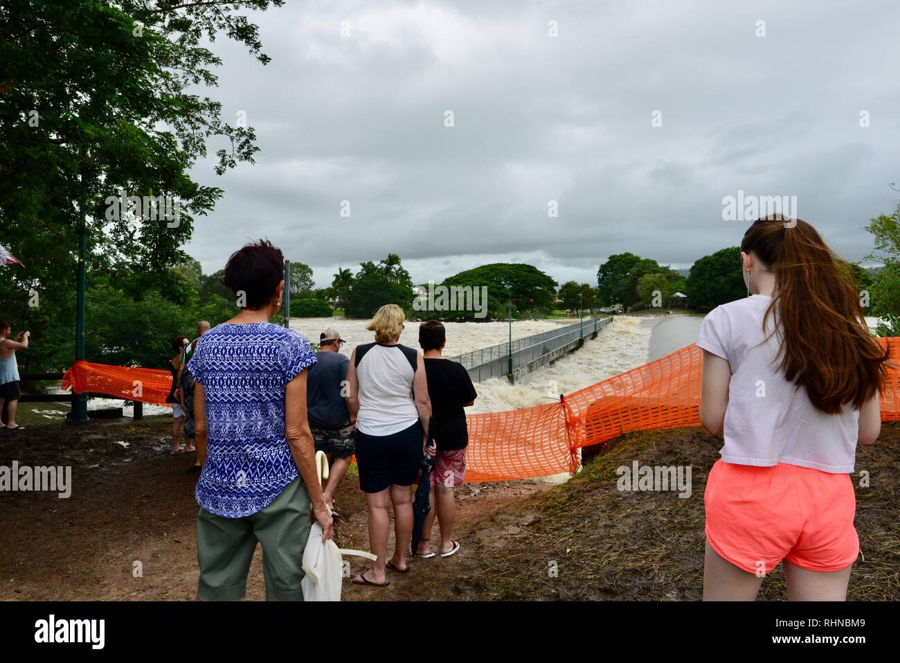 Crowds of people watching the Ross River flood at Aplin's weir, Queensland,  Australia. February 2019. Flooding continued to worsen as the deluge  continued and more water was released from the bulging Ross