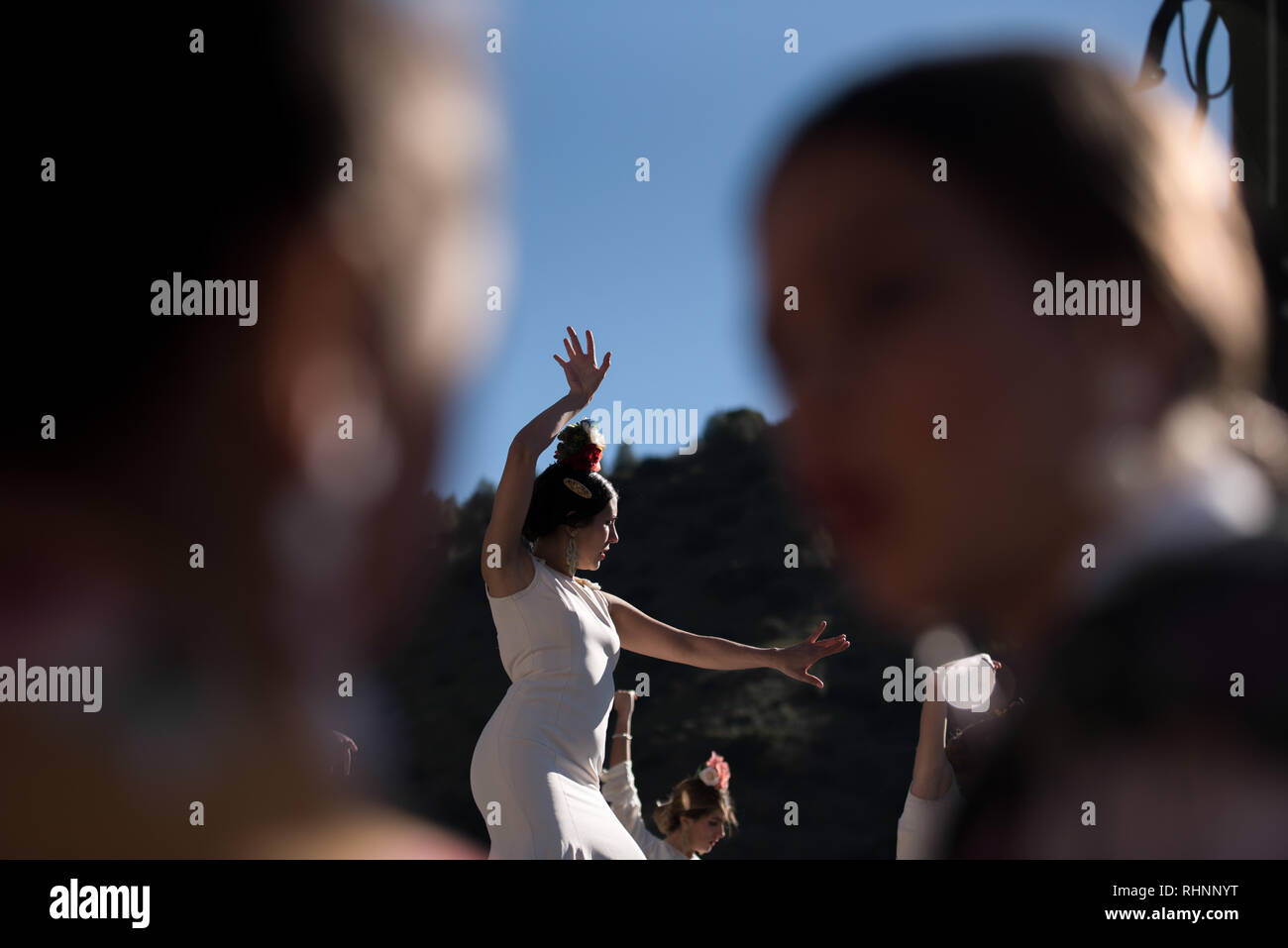 A girl seen dancing flamenco during the dance show in the festivity. Every year thousands of people in Granada come to celebrate in the neighborhood of Sacromonte the Pilgrimage of San Cecilio. Here they distribute bread with salt and oil called 'salaillas' and beans while people enjoy a flamenco dance show. Stock Photo