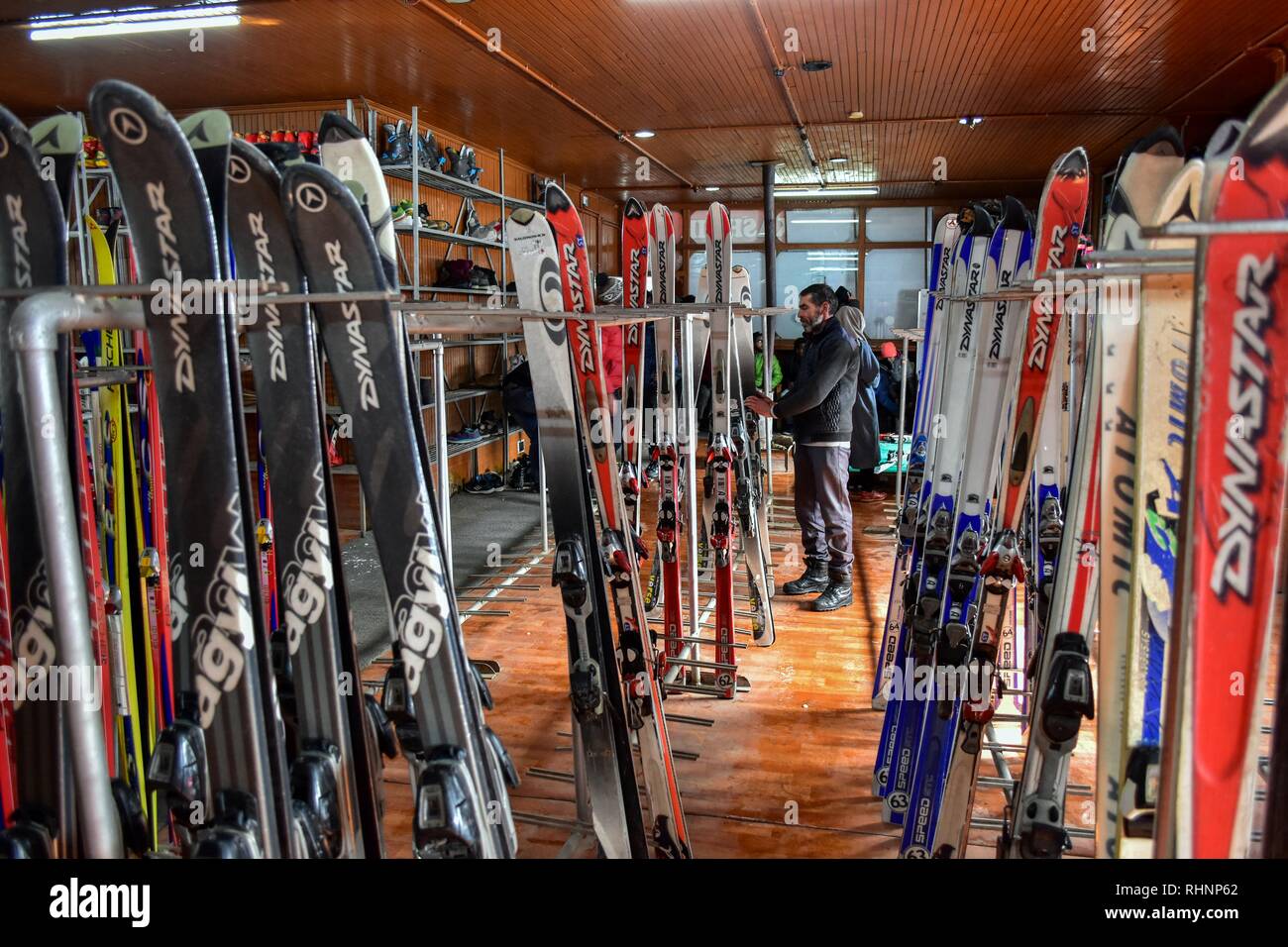 A man seen sorting ski- boards at a famous ski resort in Gulmarg, about 55kms from Srinagar, Indian administered Kashmir. Gulmarg, situated in the foothills of the Himalayas at 2,745 meters (9,000 feet) above sea level, is regarded as one of the leading ski destinations in South Asia. Stock Photo
