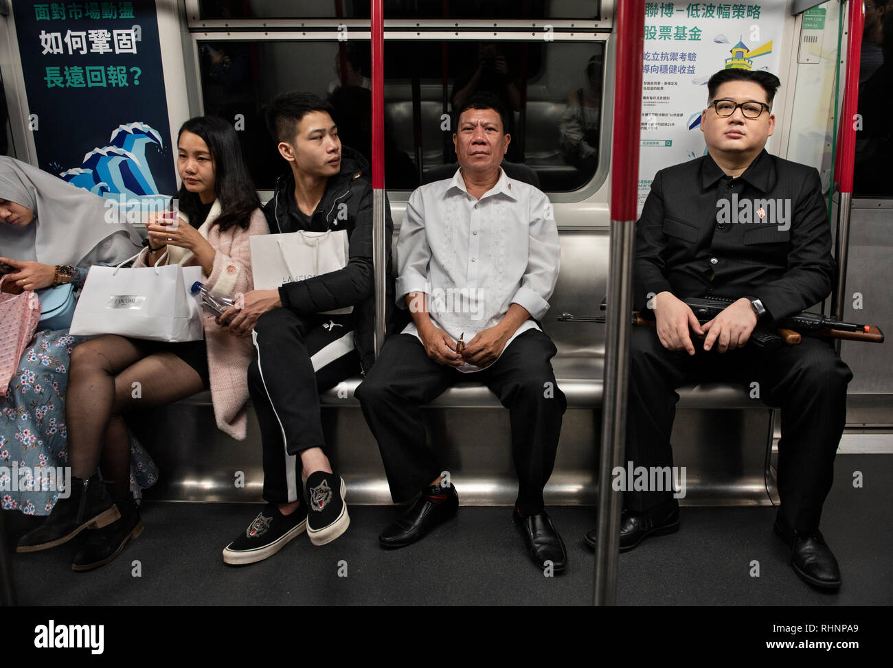 Rodrigo Duterte and Kim Jong-un impersonators seen in the subway to the surprise of commuters in Hong Kong. The impersonators of Filipino president Rodrigo Duterte who goes by the name Cresencio Extreme and North Korean Leader Kim Jong-un who goes by the name Howard X appear in the city of Hong Kong together to meet with the locals and the Filipino migrant workers community. Stock Photo