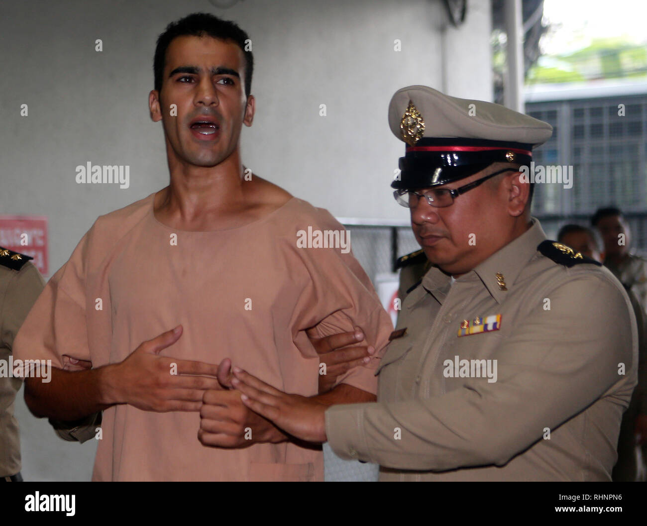 Detained Bahraini soccer player Hakeem al-Araibi is seen escorted by prison officers as he arrives at the criminal court to submit his evidence to fight against his extradition, after a local prosecutor submitted Bahrain's extradition request for him. Stock Photo