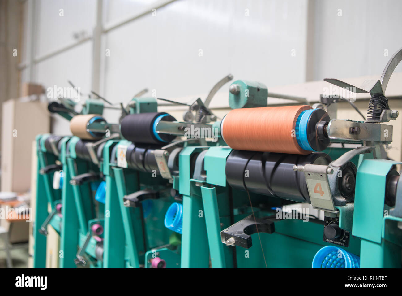 Group of bobbin thread cones on a warping machine in a textile mill. Yarn ball making in a