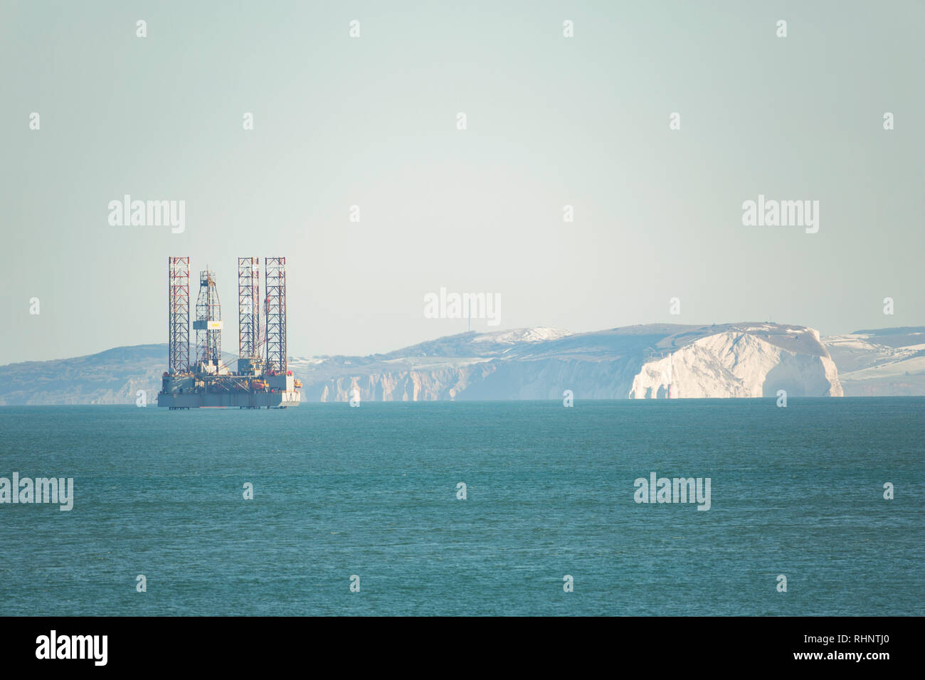 An ENSCO 72 oil rig against a backdrop of the Isle of Wight. The rig will be drilling to a depth of more than 1000 metres into the seabed in th Stock Photo