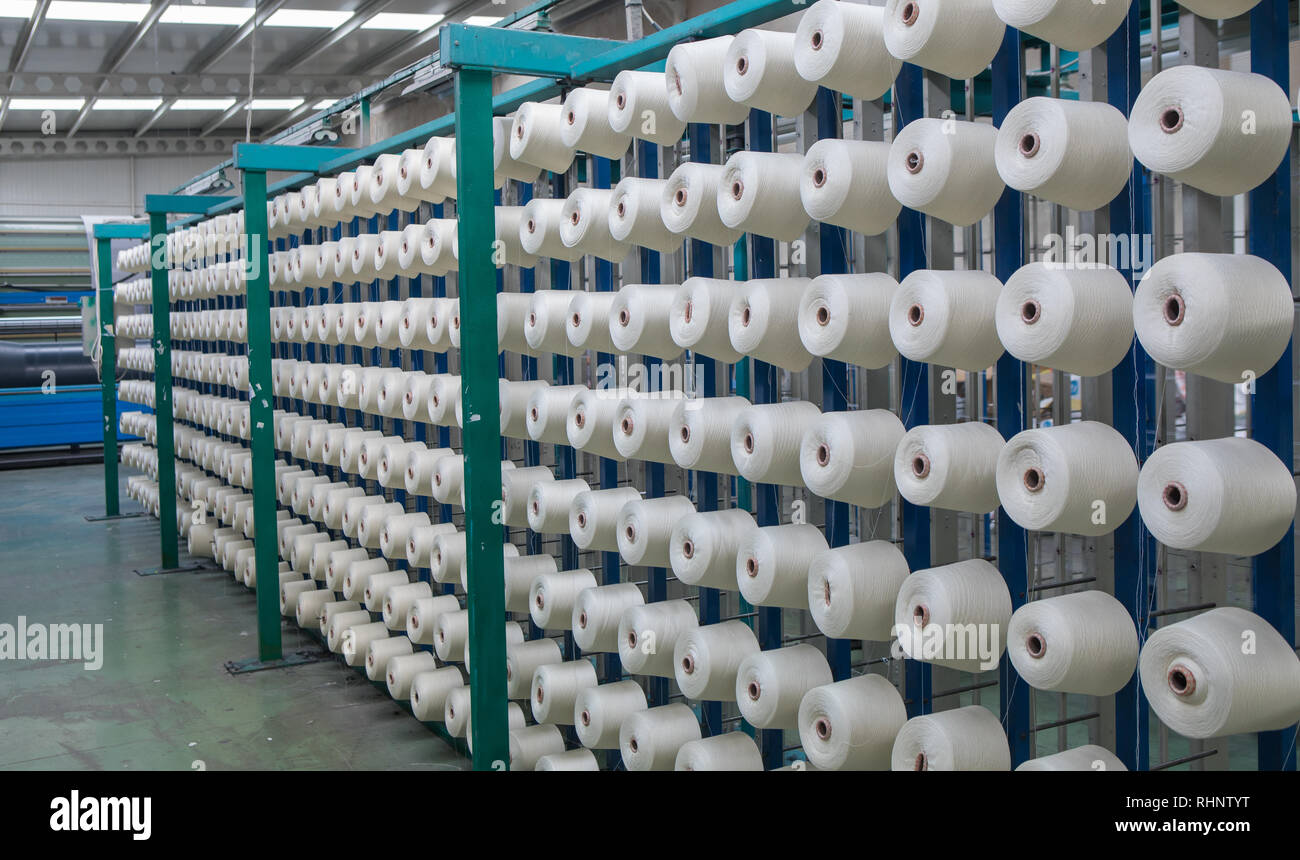 Group of bobbin thread cones on a warping machine in a textile mill. Yarn ball making in a