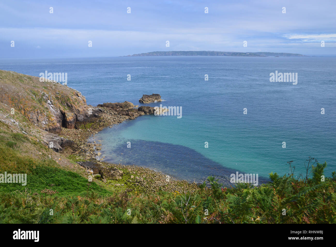 The Island of Alderney from the Coastal Path on Cliffs near Rosiere Steps on Herm Island, Channel Islands.UK. Stock Photo