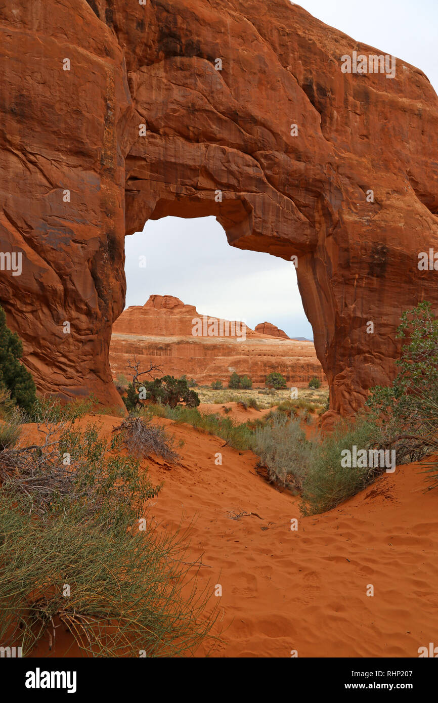 An overcast shot of the Pine Tree Arch in the Devils Garden in Arches National Park, Utah. Stock Photo