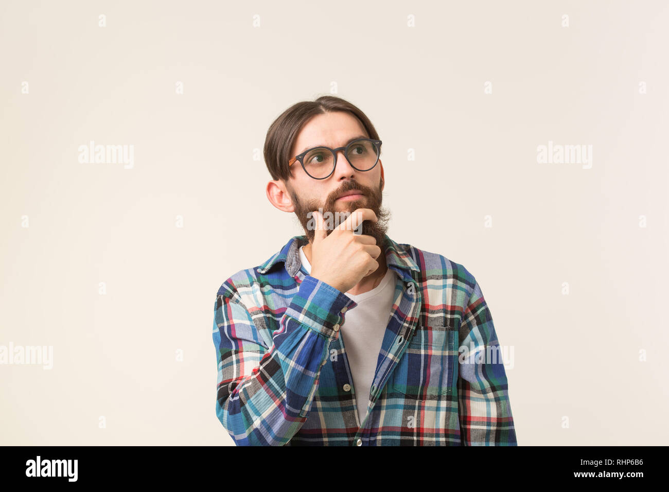 Emotions and people concept - Bearded hipster man thinking about ...