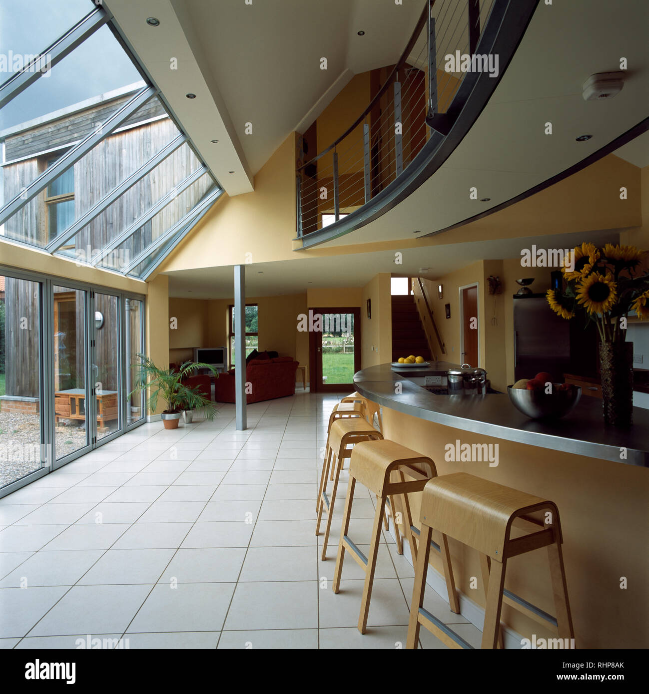 Zinc topped counter on breakfast bar in kitchen with glass wall Stock