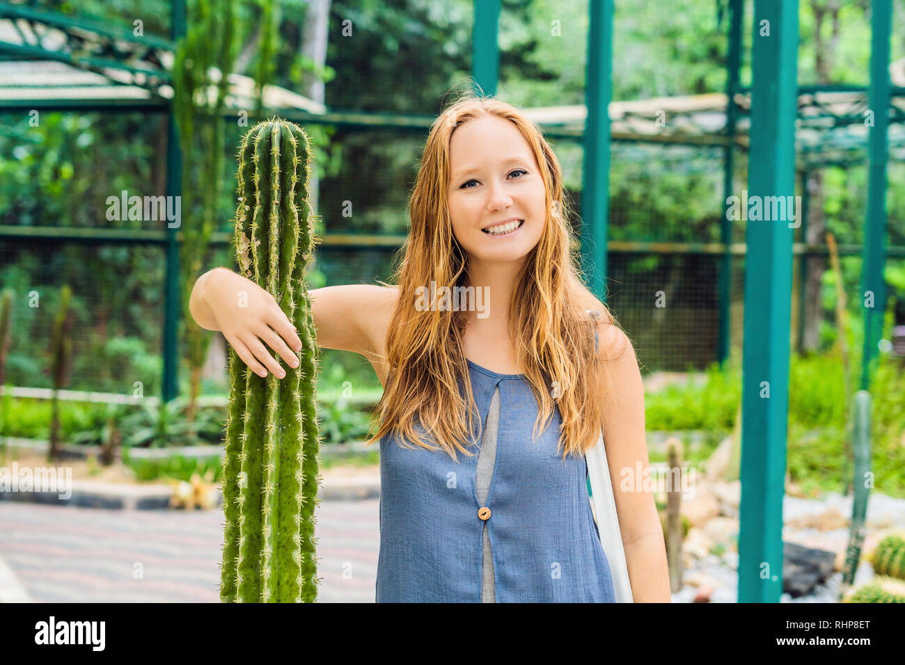 A woman hugs a cactus as her best friend. Problems of friendship concept Stock Photo